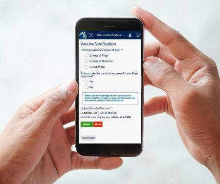 stlcc mobile app vax incentive screen capture, with hands holding smart phone. Img #2